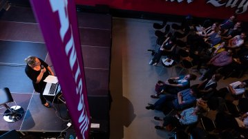 woman on stage in front of audience